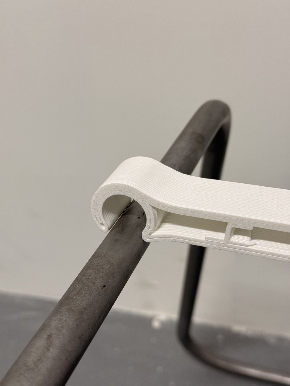 3D-printed saddle seat clipped onto a metal frame &mdash; furniture prototype