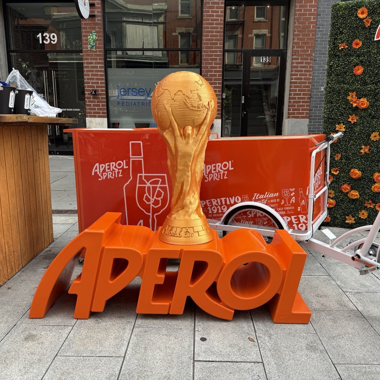 3D-printed World Cup trophy on an Aperol brand activation cart in Jersey City