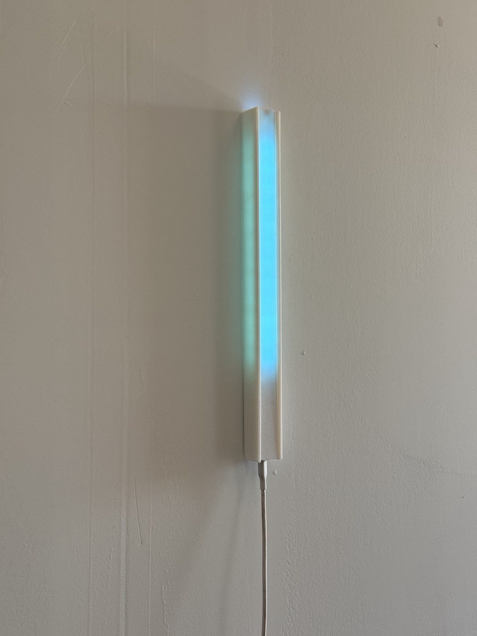 Pair of 3D-printed LED light bars &mdash; one off, one glowing blue
